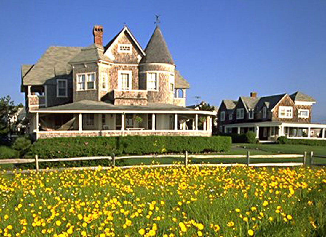 Home Insurance - East Chop House in Martha's Vineyard on a Sunny Day with Field and Yellow Flowers in Foreground