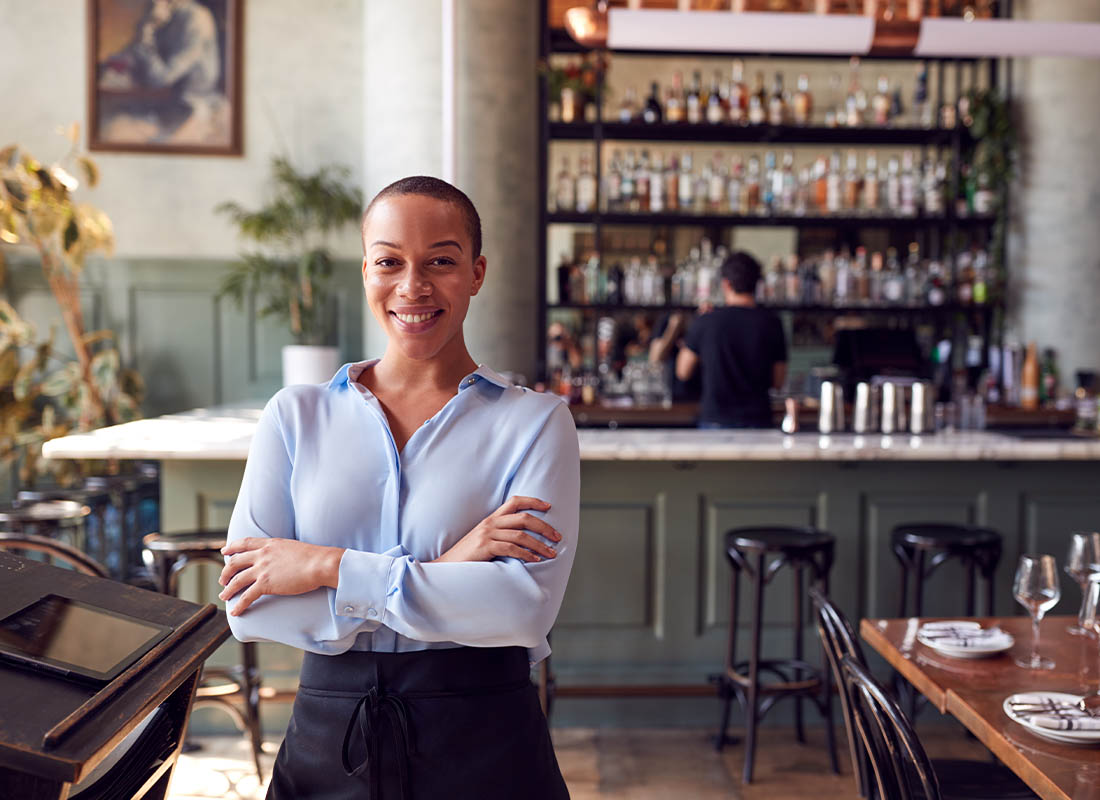 Industry by Industry - Portrait of Confident Female Owner of Restaurant Bar Standing by the Counter